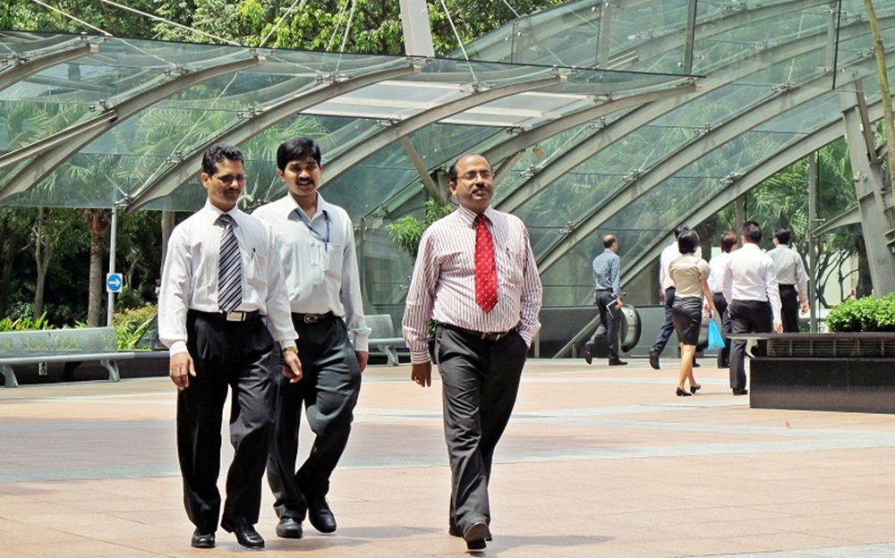 Can firms hire Indian professionals in Singapore without valid work passes, or without adhering to fair employment guidelines?